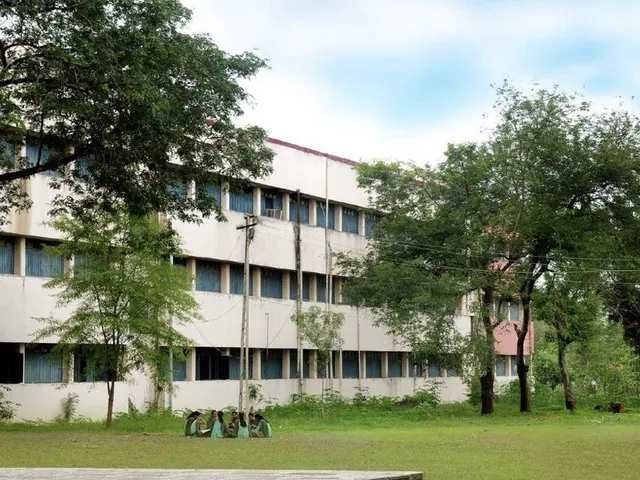 Arts, Science and Commerce College building, seen across a lawn among trees