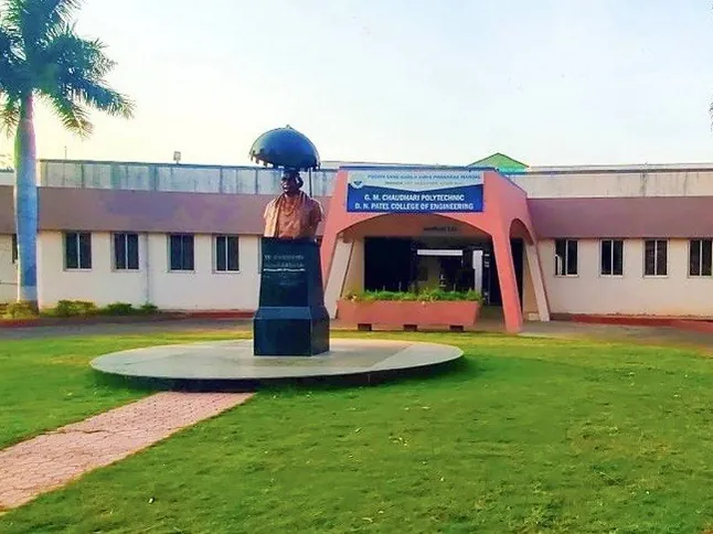 GM Chaudhari Polytechnic College, with a bust on a circular plinth in front of the college building